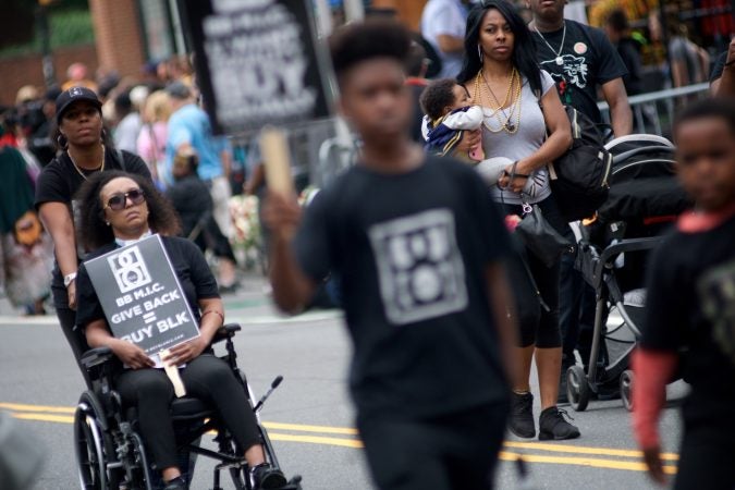 Parade participants promote the Buy Black campaign during the Juneteenth Parade, in Center City, on Saturday. (Bastiaan Slabbers for WHYY)