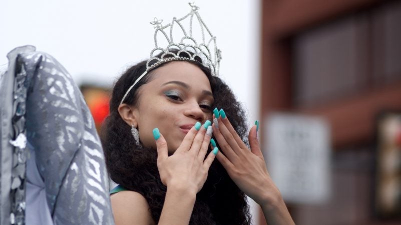 A parade participant blows hand kisses from a float during the Juneteenth Parade, in Center City, on Saturday. (Bastiaan Slabbers for WHYY)