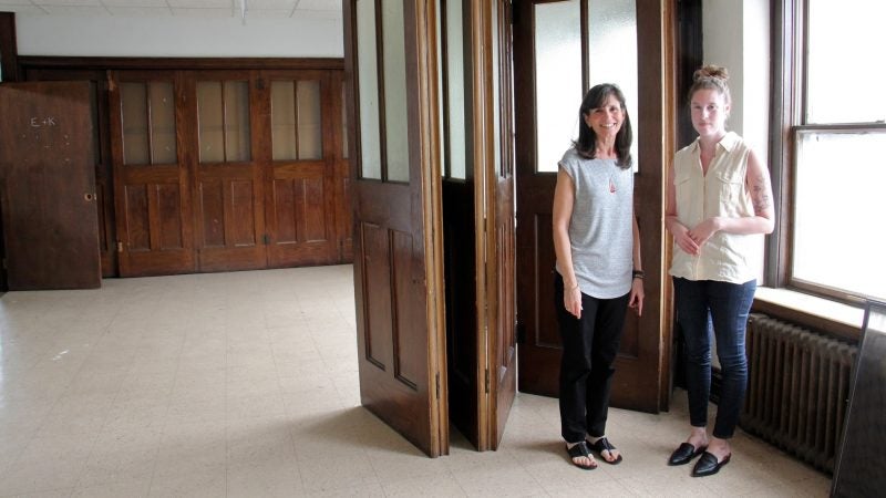 Heidi Segall Levy of Community Design Collaborative (left) and Rachel Hildebrandt of Partners for Sacred Places explore unused classroom space in Wharton-Wesley United Methodist Church. (Emma Lee/WHYY)