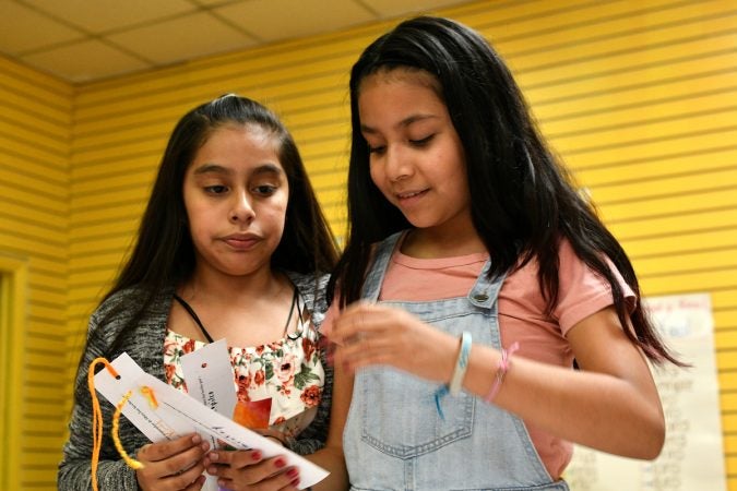 Alma, 11, and Yaretzy, 11, made bookmarks at Mighty Writers El Futuro in South Philadelphia. (Bastiaan Slabbers for WHYY)