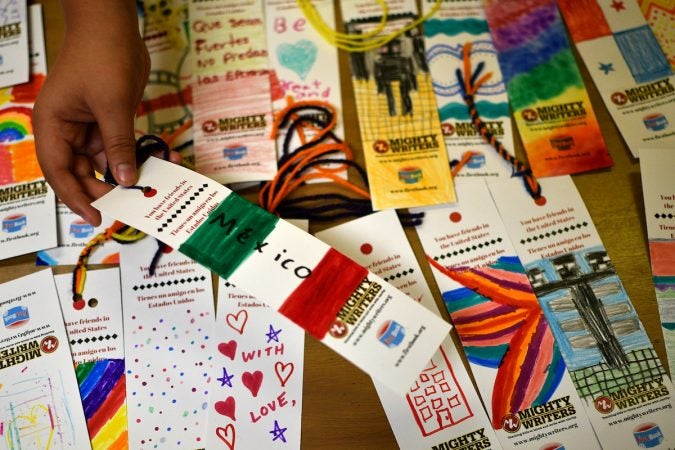 At Mighty Writers El Futuro in South Philadelphia, children donate books and make bookmarks for kids and immigrant families held at the Berks County Detention Center, during a workshop Thursday. (Bastiaan Slabbers for WHYY)