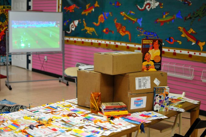 At Mighty Writers El Futuro in South Philadelphia, children donate books and make bookmarks for kids and immigrant families held at the Berks County Detention Center, during a workshop Thursday. (Bastiaan Slabbers for WHYY)
