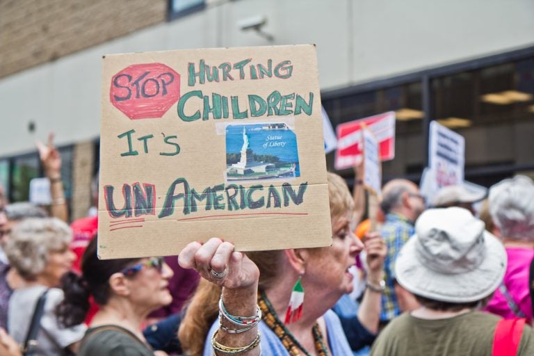 Abbie Hyde protests the practice of separating children from their families outside of the Center City offices of ICE in Philadelphia. (Kimberly Paynter/WHYY)