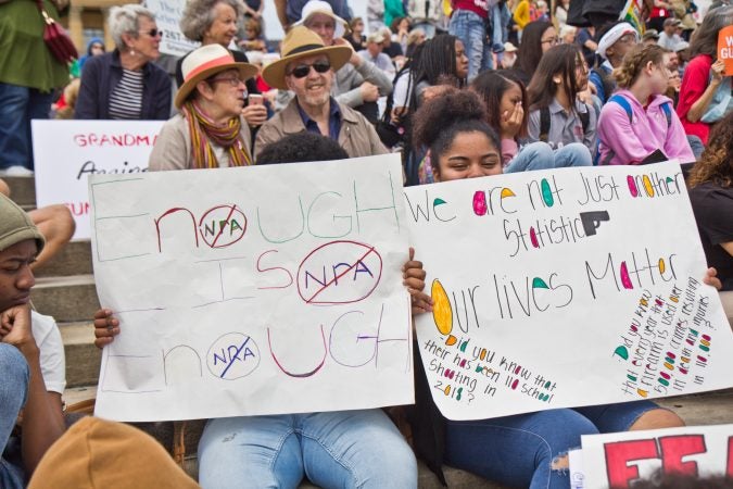 Tiana Johns, 16, and Amyrie Allen, 15, take part in a demonstration against gun violence because they are tired of hearing gunshots in their neighborhoods. (Kimberly Paynter/WHYY)