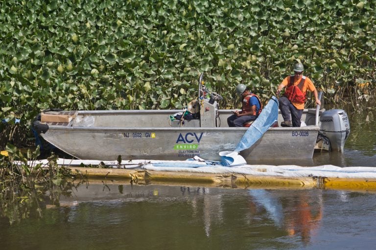 An environmental cleanup crew works to remove gasoline fuel from an ETP pipeline spill in Darby creek in Tinicum Township, Pennsylvania, last week. (Kimberly Paynter/WHYY)