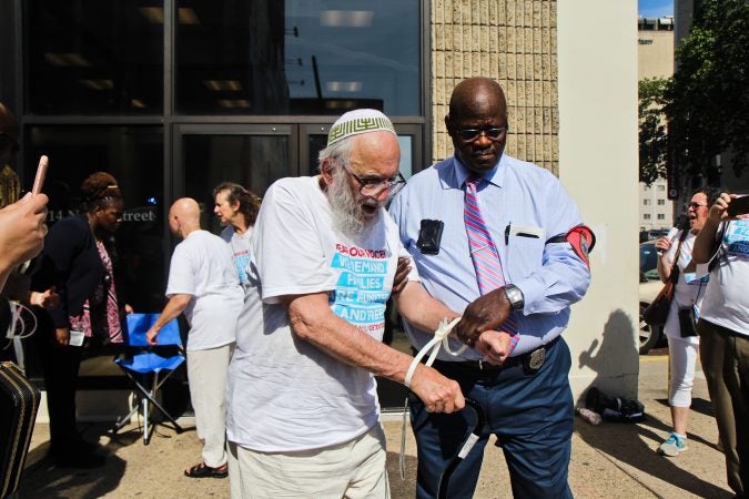 A senior citizen's group called The Old Farts were arrested in front of Philadelphia’s ICE headquarters Friday morning in protest of the Trump administration’s family separation policy. (Kimberly Paynter/WHYY)