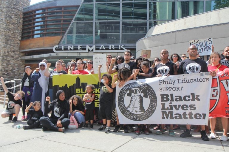 Demonstrators rally outside the Cinemark Theatres in Philadelphia. Last week, police were called on a black family who were unsatisfied with their movie experience. (Kimberly Paynter/WHYY)