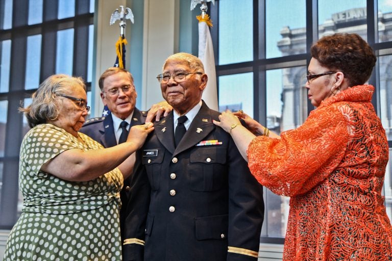 John Edward James Jr., an Army veteran of World War II, is pinned with the rank of second lieutenant by his daughters Brenda Roberta Watts (left) and Dr. Marion Teresa Lane. (Kimberly Paynter/WHYY)