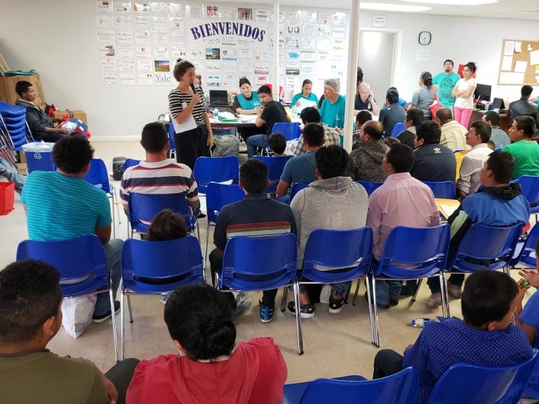 About 100 newly arrived immigrants listen to a volunteer walk them through the process to seek asylum at a Catholic Charities respite center in McAllen, Texas. About 100 newly arrived immigrants listen to a volunteer walk them through the process to seek asylum at a Catholic Charities respite center in McAllen, Texas. (Mose Buchele/KUT)
