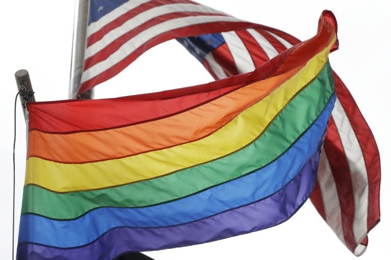 The Rainbow Flag flies beneath the American flag at the Stonewall National Monument, Wednesday, Oct. 11, 2017, in New York. The Rainbow Flag, an international symbol of LGBT liberation and pride, was flown for the first time at the monument. (Mark Lennihan/AP Photo)