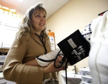 In this file photo, a nurse practitioner takes the blood pressure of a co-worker at a wellness center in Petersburg, Va., Thursday, Jan. 25, 2018. (Steve Helber/AP Photo)