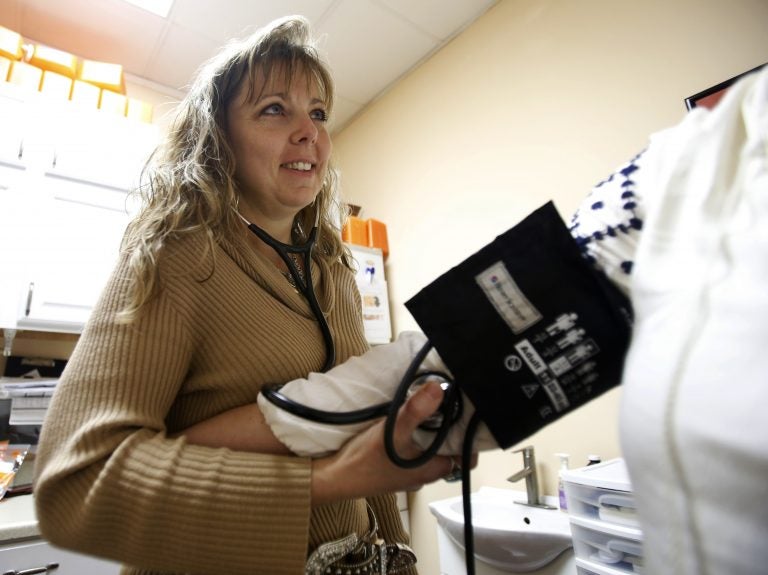 In this file photo, a nurse practitioner takes the blood pressure of a co-worker at a wellness center in Petersburg, Va., Thursday, Jan. 25, 2018. (Steve Helber/AP Photo)