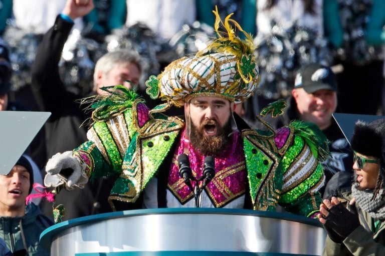 Eagles center Jason Kelce speaks from a podium while decked out in a Mummers outfit