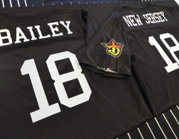 A sports jersey for Morris Bailey, left, the owner of the Resorts Casino Hotel in Atlantic City, N.J., and another for Jason Robins, CEO and co-founder of DraftKings, adorn a table at the offices of DraftKings, in New York, Friday, June 1, 2018. DraftKings and Resorts Casino tell The Associated Press they signed a deal Friday to offer sports betting in New Jersey. (Richard Drew/AP Photo)