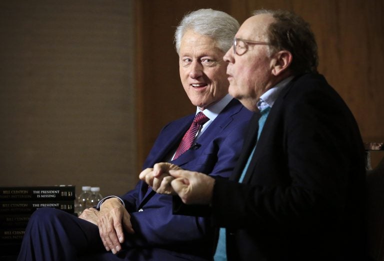 In this file photo, former President Bill Clinton listens as author James Patterson speaks during an interview about their new novel, 