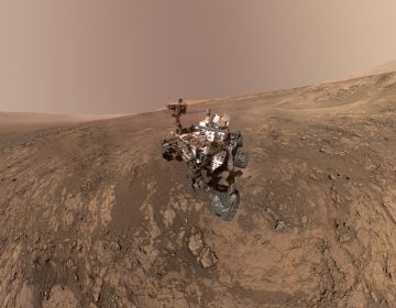 This composite image made from a series of Jan. 23, 2018 photos shows a self-portrait of NASA's Curiosity Mars rover on Vera Rubin Ridge. On Thursday, June 7, 2018, scientists said the rover found potential building blocks of life in an ancient lakebed and confirmed seasonal increases in atmospheric methane. The rover's arm which held the camera was positioned out of each of the dozens of shots which make up the mosaic. (NASA/JPL-Caltech/MSSS via AP)