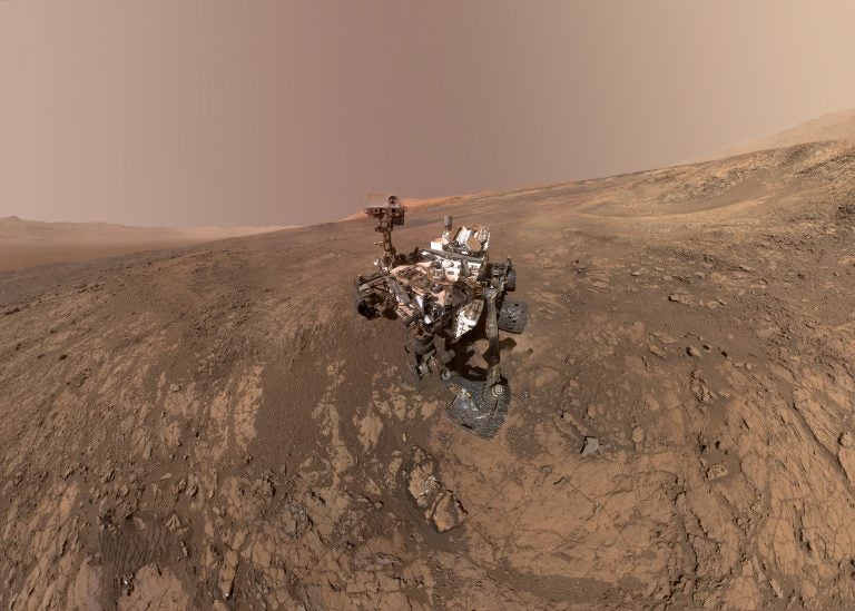 This composite image made from a series of Jan. 23, 2018 photos shows a self-portrait of NASA's Curiosity Mars rover on Vera Rubin Ridge. On Thursday, June 7, 2018, scientists said the rover found potential building blocks of life in an ancient lakebed and confirmed seasonal increases in atmospheric methane. The rover's arm which held the camera was positioned out of each of the dozens of shots which make up the mosaic. (NASA/JPL-Caltech/MSSS via AP)