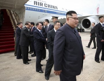 In this photo released by the Ministry of Communications and Information of Singapore, North Korean leader Kim Jong Un, right, arrives at the Changi International Airport, Sunday, June 10, 2018, in Singapore ahead of a summit with U.S. President Donald Trump. (Ministry of Communications and Information of Singapore via AP)