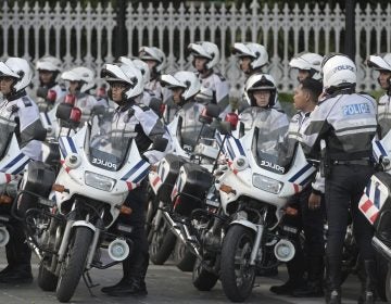 Police officers escorting the motorcade of North Korea leader Kim Jong Un park after he arrives at the Istana, or Presidential Palace, in Singapore on Sunday, June 10, 2018, to meet Singapore Prime Minister Lee Hsien Loong. (AP Photo/Joseph Nair)