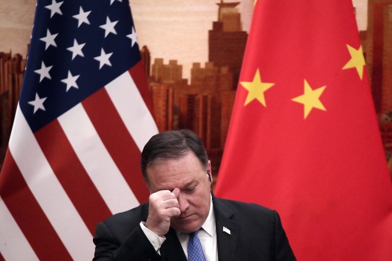 U.S. Secretary of State Mike Pompeo rubs his forehead during a joint press conference with Chinese Foreign Minister Wang Yi at the Great Hall of the People in Beijing, Thursday, June 14, 2018. (Andy Wong/AP Photo)