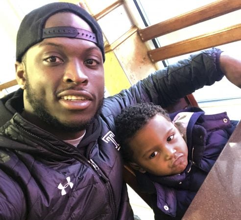 In this Feb. 10, 2018 photo, former Temple running back David Hood takes a selfie with his son, David IV in Mays Landing, N.J. Hood, who was Temple’s leading rusher last season, was one of four Owls players parenting young children in 2017. Hood, 21, has moved on from football, graduating from Temple and leaving a year of football eligibility behind after sustaining a concussion this past spring. He has decided to focus solely on a promising career as a rapper. (David Hood via AP)