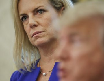 Homeland Security Secretary Kirstjen Nielsen, left, listens to President Donald Trump, right, speaks to members of the media after Trump signed an executive order to end family separations, during an event in the Oval Office of the White House in Washington, Wednesday, June 20, 2018.