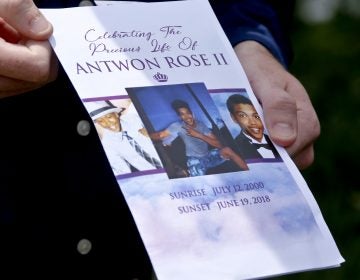 Kyle Fogarty shows the program for the funeral for Antwon Rose Jr. on Monday, June 25, 2018, in Swissvale, Pa. Rose was fatally shot by a police officer seconds after he fled a traffic stop June 19, in the suburb of East Pittsburgh. Fogarty said he was a classmate of Rose and had to attend the service. (Keith Srakocic/AP Photo)