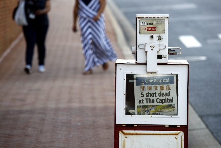 A Capital Gazette newspaper rack displays the day's front page, Friday, June 29, 2018, in Annapolis, Md. A man armed with smoke grenades and a shotgun attacked journalists in the newspaper's building Thursday, killing several people before police quickly stormed the building and arrested him, police and witnesses said. (Patrick Semansky/AP Photo)