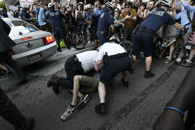 Police cleared the path as a government vehicle navigates through the crowd near Walnut and 19th streets. (Bastiaan Slabbers for WHYY)