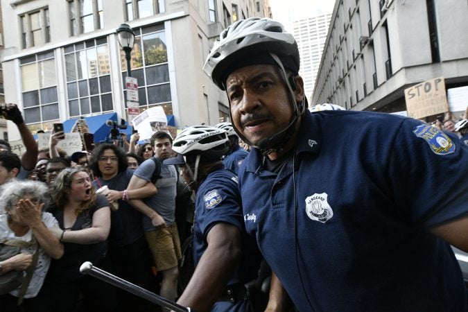 Philadelphia police officer at Tuesday's protest of the Trump administration's immigration policies. (Bastiaan Slabbers for WHYY)