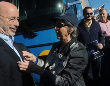 Tom Wolf's mother, Cornelia, straightens out his coat following a rally before to kick off his bus tour on Friday, Oct. 24, 2014. (York Daily Record file)