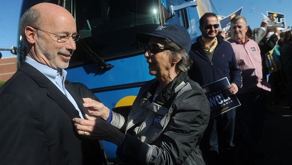 Tom Wolf's mother, Cornelia, straightens out his coat following a rally before to kick off his bus tour on Friday, Oct. 24, 2014. (York Daily Record file)