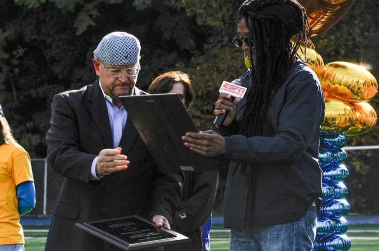 Muzz Skillings alongside Joe Krause, Audible board member, presenting a plaque for Autism Awareness. (Photo Courtesy/Audible for Autism)