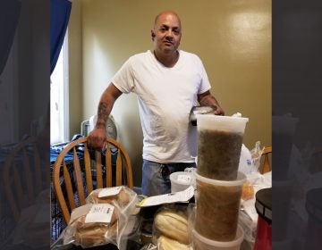 Feliciano Pagan, a Medicaid recipient in Philadelphia, looks over his medically tailored meals made at the kitchens of the nonprofit MANNA and paid for by Health Partners Plans, his Medicaid health plan.