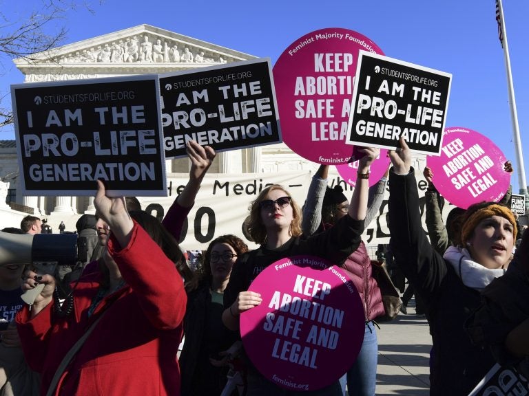 Protesters on both sides of the abortion issue gather outside the Supreme Court in Washington on Jan. 19 during the March for Life. (Susan Walsh/AP)