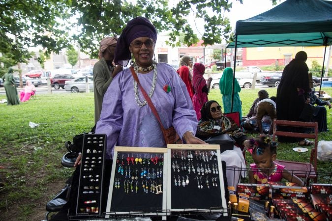 Safiyat Muhammad sells earrings she made at an Eid al-Fitr celebration, marking the end of Ramadan. (Kimberly Paynter/WHYY)