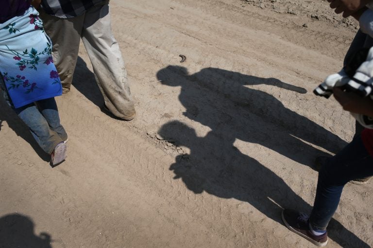 Central American immigrant families walk after crossing from Mexico into the United States to seek asylum in Texas. (John Moore/Getty Images)