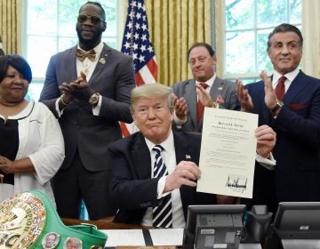 President Trump signs a posthumous pardon for boxer Jack Johnson on May 24. The White House has privately asked prisoner advocates in recent weeks for the names of more potential clemency candidates. (Olivier Douliery-Pool/Getty Images)