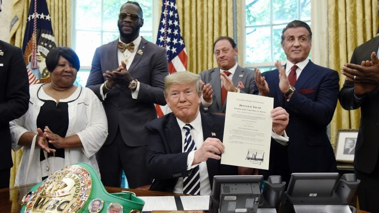 President Trump signs a posthumous pardon for boxer Jack Johnson on May 24. The White House has privately asked prisoner advocates in recent weeks for the names of more potential clemency candidates. (Olivier Douliery-Pool/Getty Images)