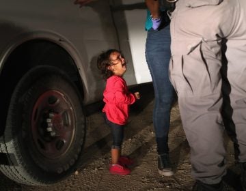 A 2-year-old Honduran asylum seeker cries as her mother is searched and detained near the U.S.-Mexico border on June 12 in McAllen, Texas. The asylum seekers had rafted across the Rio Grande River from Mexico and were detained by U.S. Border Patrol agents before being sent to a processing center for possible separation. (John Moore/Getty images)