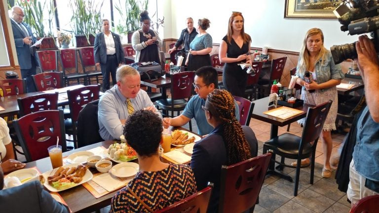 Mayor Jim Kenney chats with Chung Le, the owner of Pho Saigon Restaurant, in Northeast Philadelphia Monday. (Tom MacDonald/WHYY)