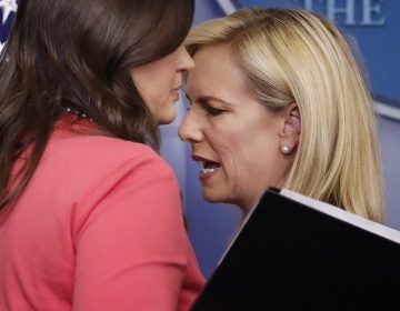 Homeland Security Secretary Kirstjen Nielsen, right, and White House press secretary Sarah Huckabee Sanders, left, talk as they switch places at the podium during the daily briefing in the Brady Press Briefing Room of the White House, Monday, June 18, 2018. (AP Photo/Pablo Martinez Monsivais)