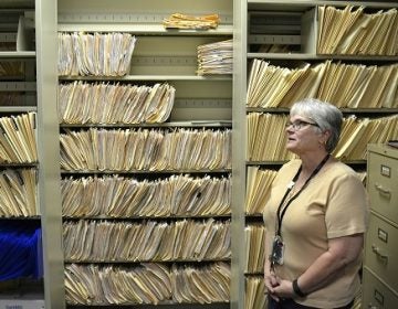 Environmental risk inspector Marilou Yingling stands in front of years worth of files related to lead found in York homes. (Brett Sholtis/Transforming Health)