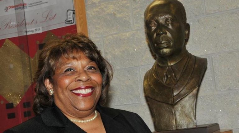 Wilma Mishoe has been named the first permanent female president of Delaware State University. She has been interim president since January. The bust next to her is of her father Luna, who was the school's president from 1960 to 1987.