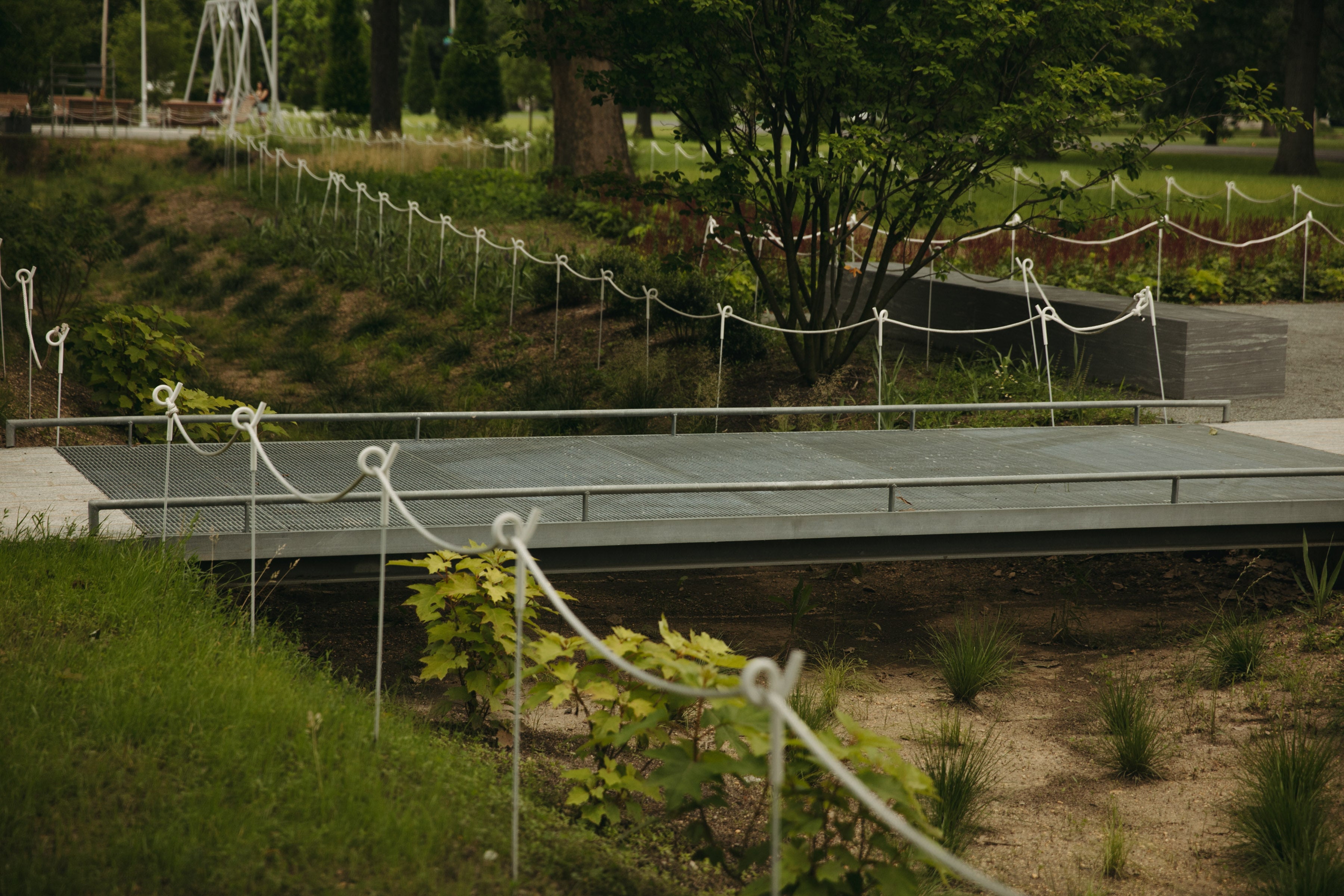 Parkside Edge's rain garden borders are spanned by small metal bridges. 