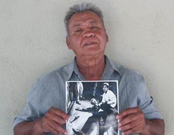 Juan Romero, 67, at his home in Modesto, Calif., holds a photo of himself and Sen. Robert F. Kennedy, taken by The Los Angeles Times' Boris Yaro on June 5, 1968. (Jud Esty-Kendall/StoryCorps)