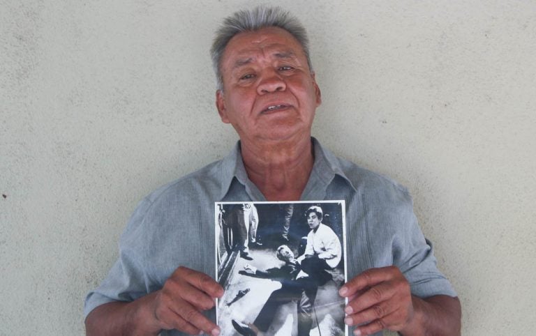 Juan Romero, 67, at his home in Modesto, Calif., holds a photo of himself and Sen. Robert F. Kennedy, taken by The Los Angeles Times' Boris Yaro on June 5, 1968. (Jud Esty-Kendall/StoryCorps)