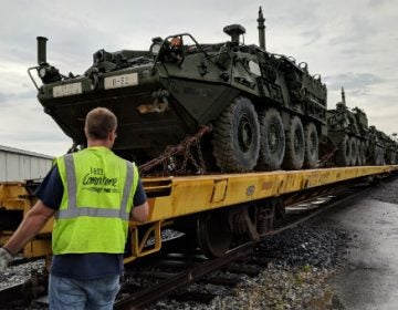 Stryker vehicles are loaded on rail cars at Naval Support Activity, Mechanicsburg to be transported to the National Training Center on June 20, 2018. (Rachel McDevitt/WITF)