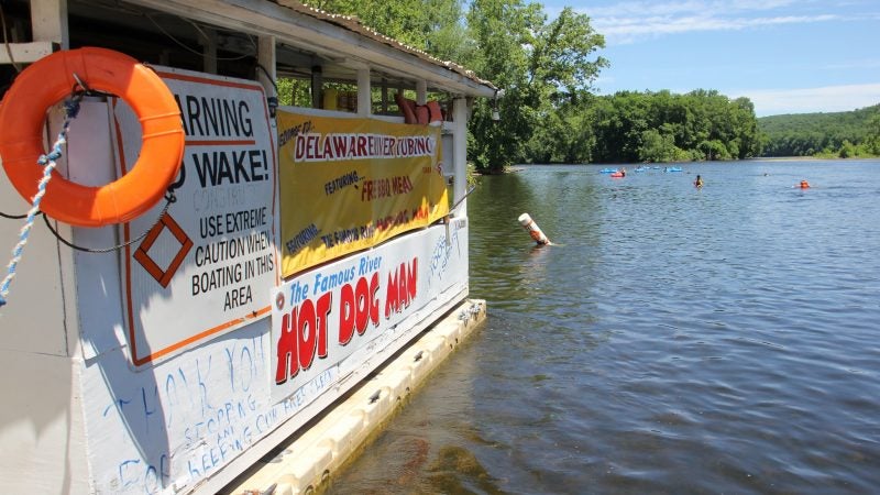 Tubers on the Delaware River approach the Famous River Hot Dog Man. Nearly all stop for a bite and a drink. (Emma Lee/WHYY)