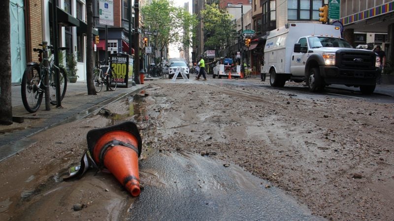Silt and debris fill Center City streets around the site of a massive water main break. (Emma Lee/WHYY)